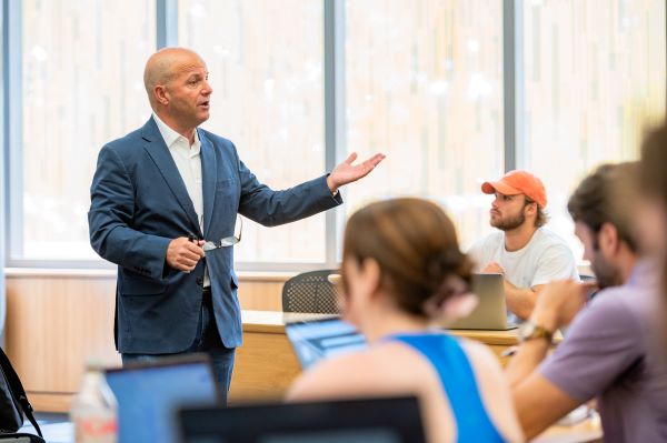 Teacher raises are while speaking to students 